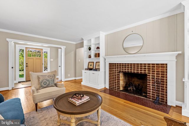 a living room with furniture a fireplace and a large window