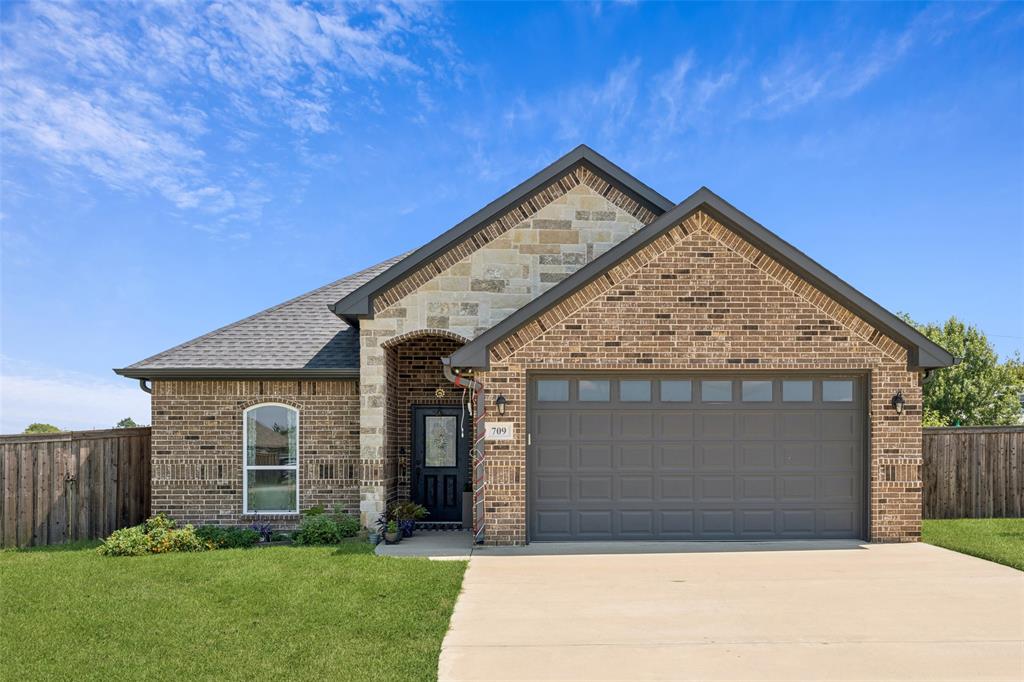 709 Coblestone Circle Mabank, TX 75147 - Photo 1 of 24 a view of a house with a small yard