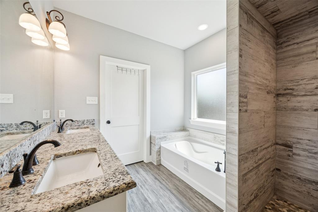 709 Coblestone Circle Mabank, TX 75147 - Photo 13 of 24 a bathroom with a tub sink and mirror