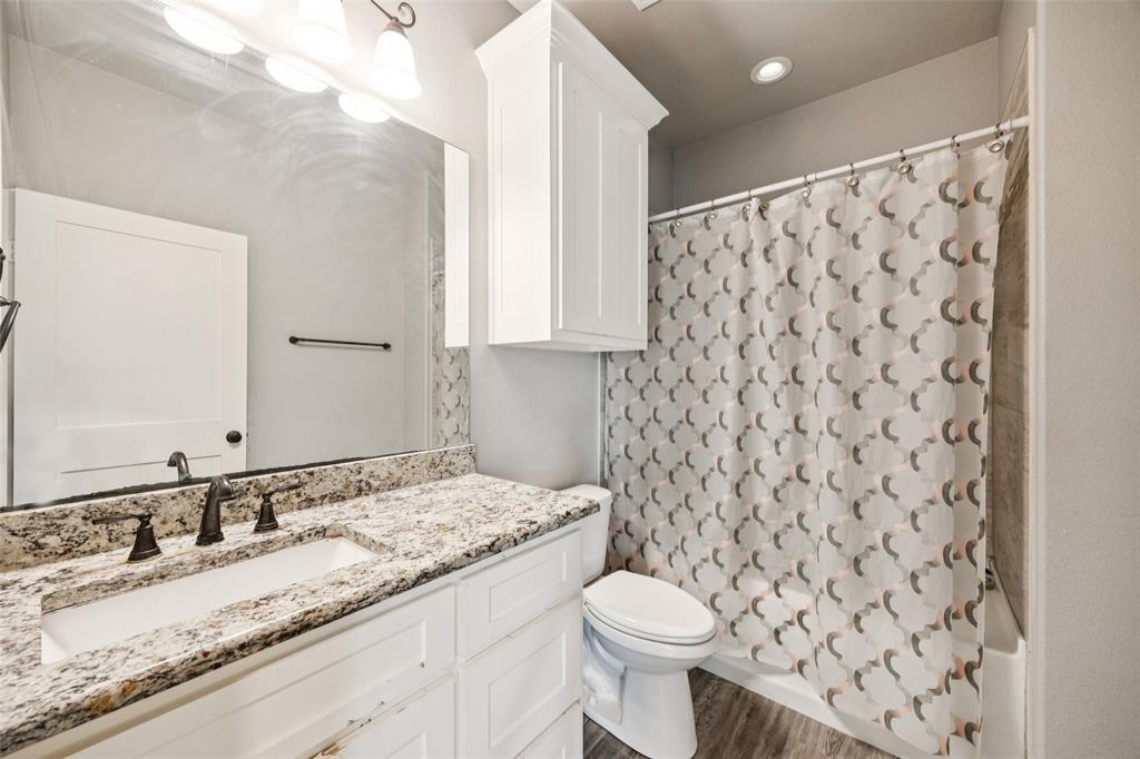 709 Coblestone Circle Mabank, TX 75147 - Photo 17 of 24 a bathroom with a granite countertop sink and a mirror