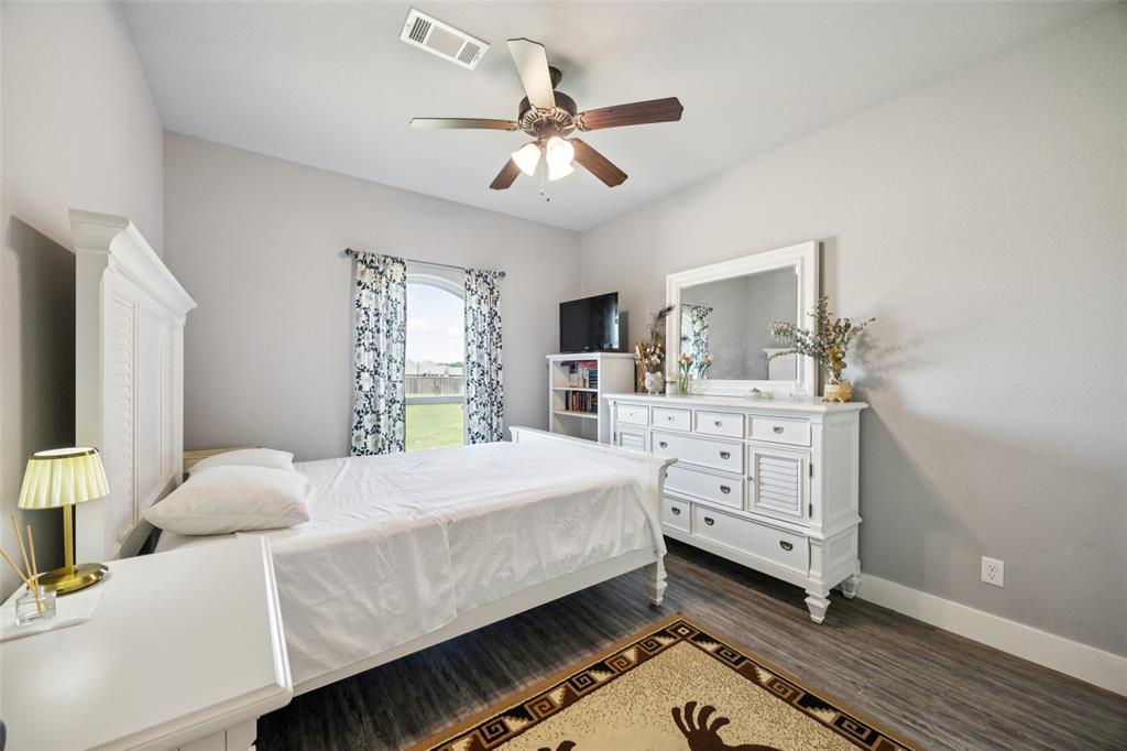709 Coblestone Circle Mabank, TX 75147 - Photo 18 of 24 a bedroom with a bed and a dresser