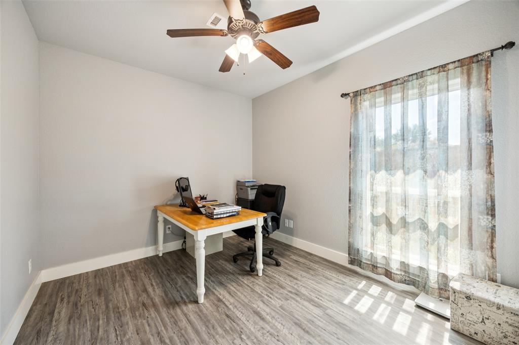 709 Coblestone Circle Mabank, TX 75147 - Photo 20 of 24 a room with wooden floor and a window