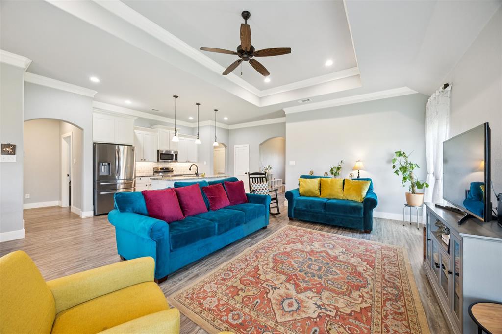 709 Coblestone Circle Mabank, TX 75147 - Photo 5 of 24 a living room with furniture kitchen view and a flat screen tv