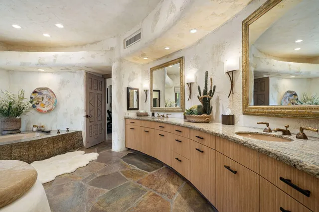 a bathroom with a tub sink and glass door