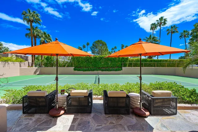 a view of a patio with chairs and a yard