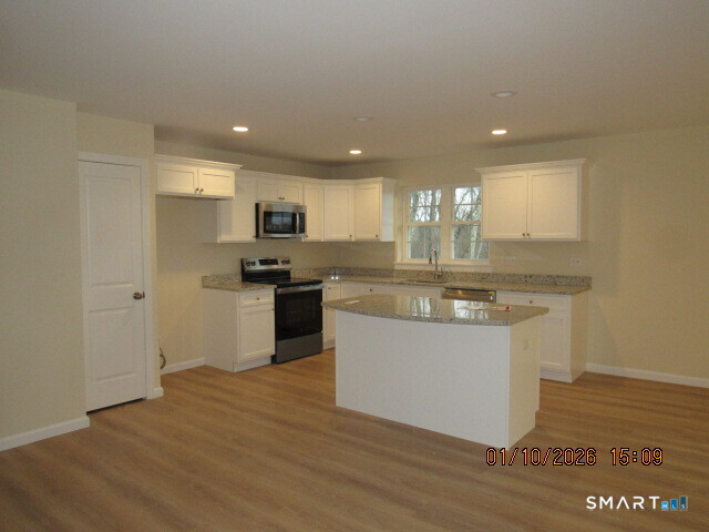 43 Warm Earth Road Naugatuck, CT 06770 - Photo 5 of 24 a kitchen with granite countertop a sink and cabinets