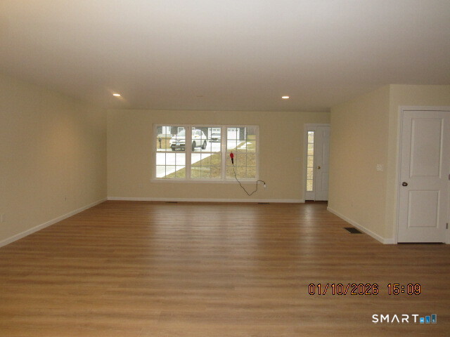 43 Warm Earth Road Naugatuck, CT 06770 - Photo 6 of 24 an empty room with wooden floor and windows