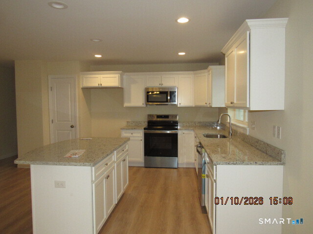 43 Warm Earth Road Naugatuck, CT 06770 - Photo 7 of 24 a kitchen with a sink stove and refrigerator