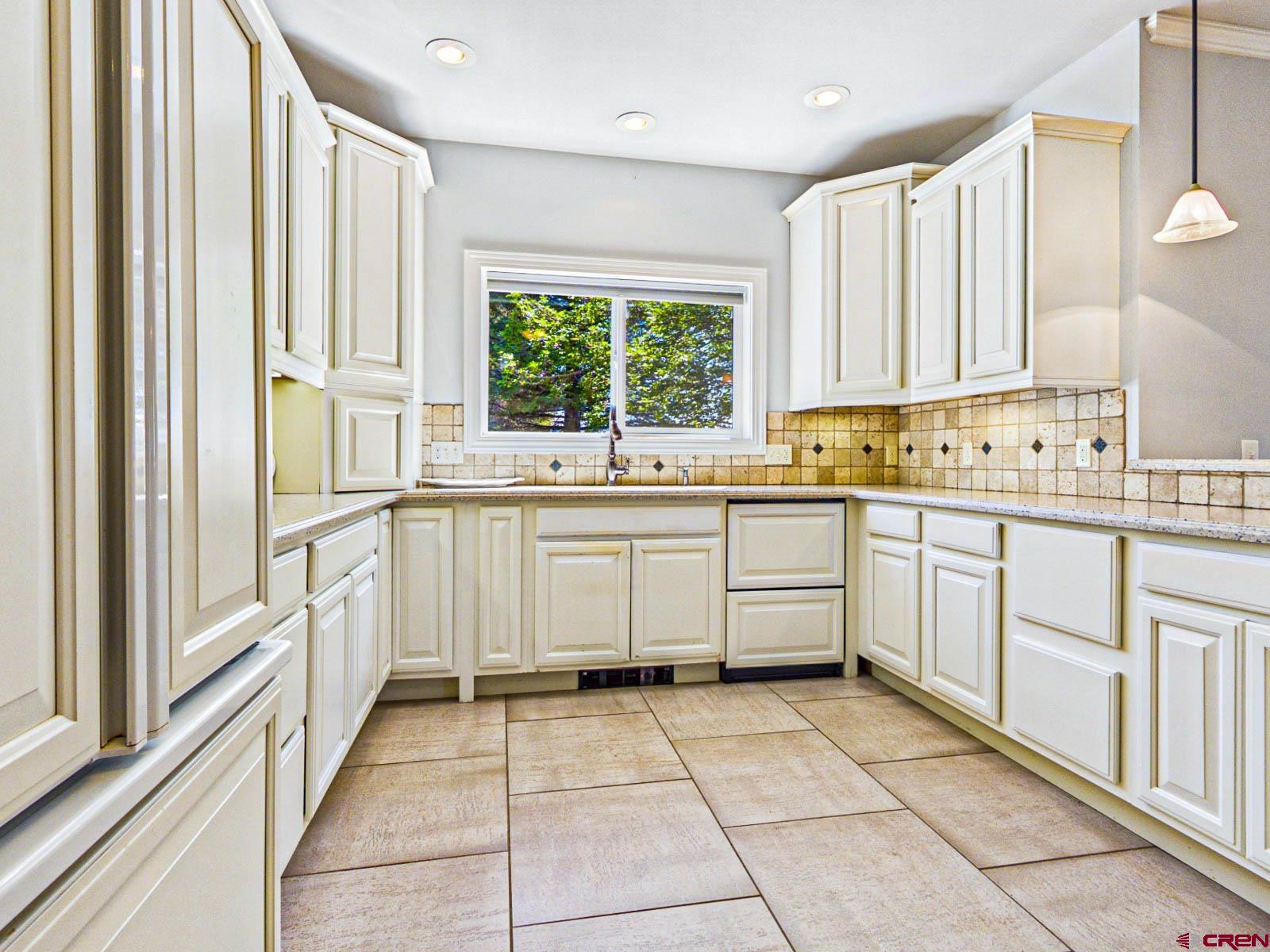 16331 2550th Road Cedaredge, CO 81413 - Photo 19 of 45 a kitchen with a stove sink and cabinets