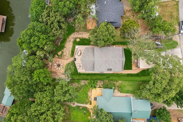 an aerial view of a house with a yard