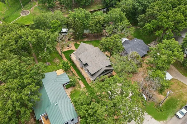 an aerial view of a house with a yard