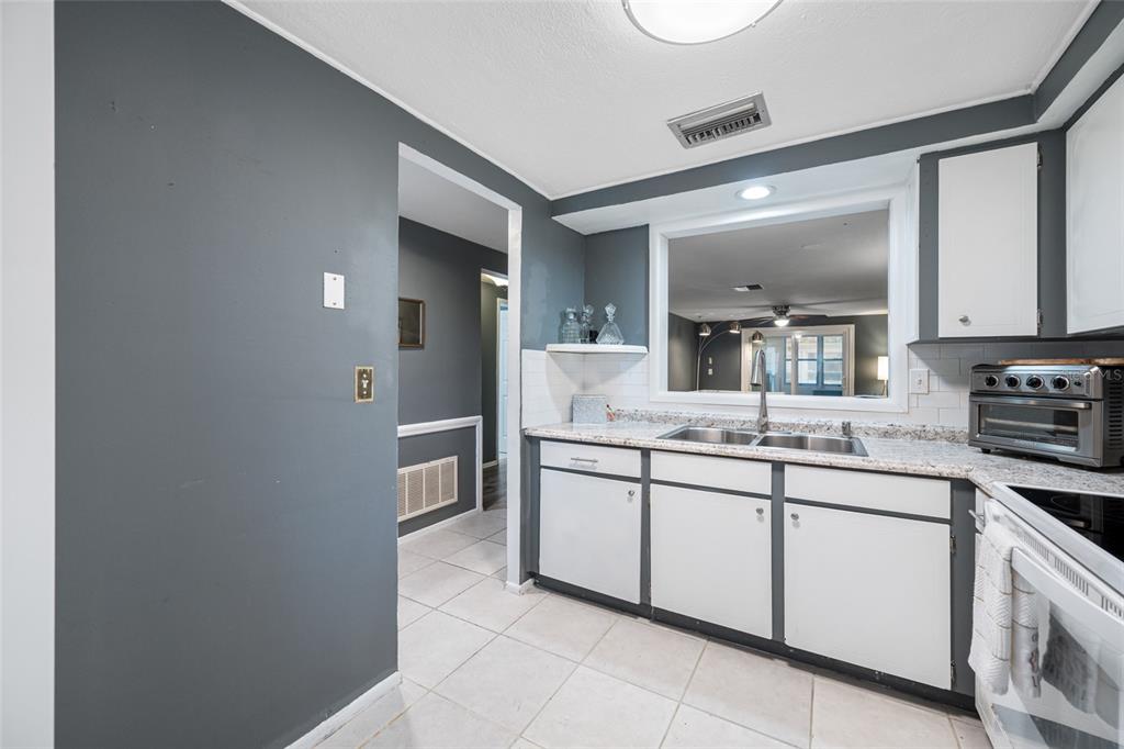 4210 Touchton Place, Unit 2 New Port Richey, FL 34652 - Photo 11 of 34 a bathroom with a sink and a mirror