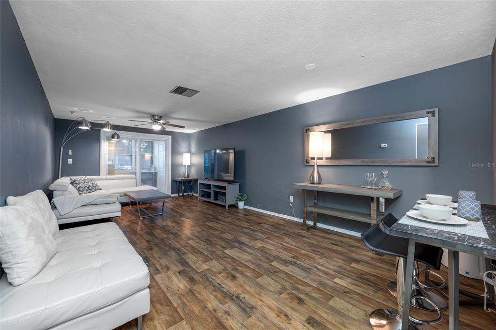 4210 Touchton Place, Unit 2 New Port Richey, FL 34652 - Photo 13 of 34 a living room with furniture and a flat screen tv