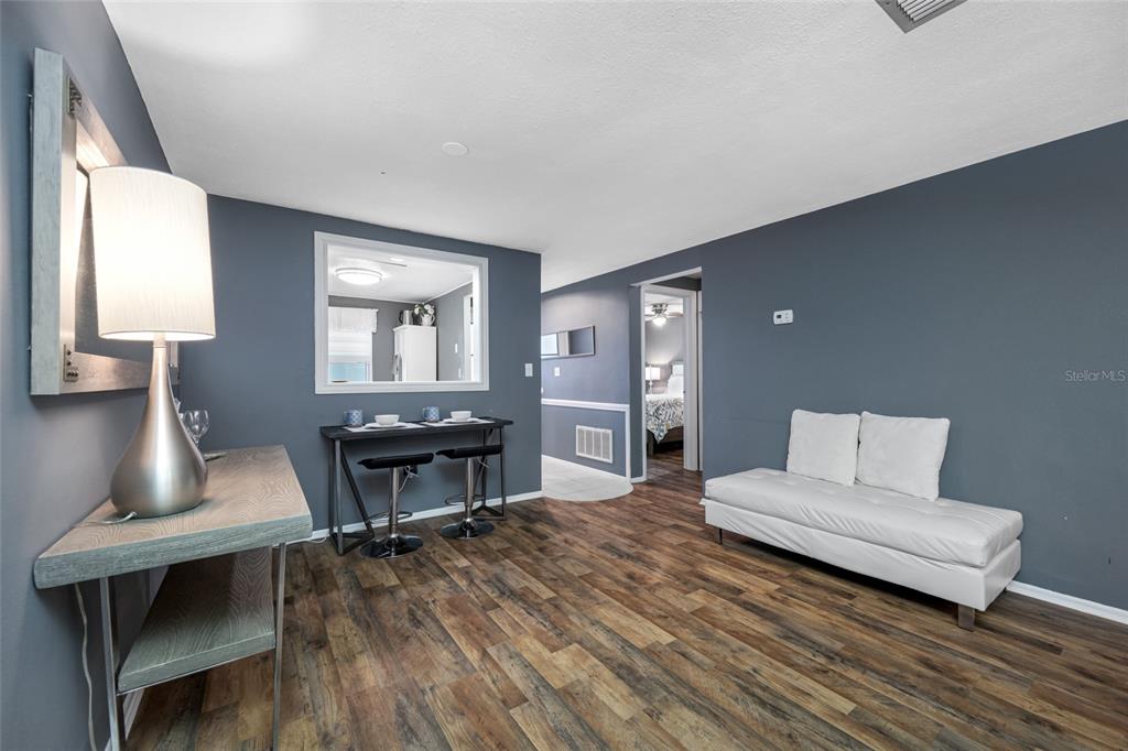 4210 Touchton Place, Unit 2 New Port Richey, FL 34652 - Photo 14 of 34 a living room with furniture and a wooden floor