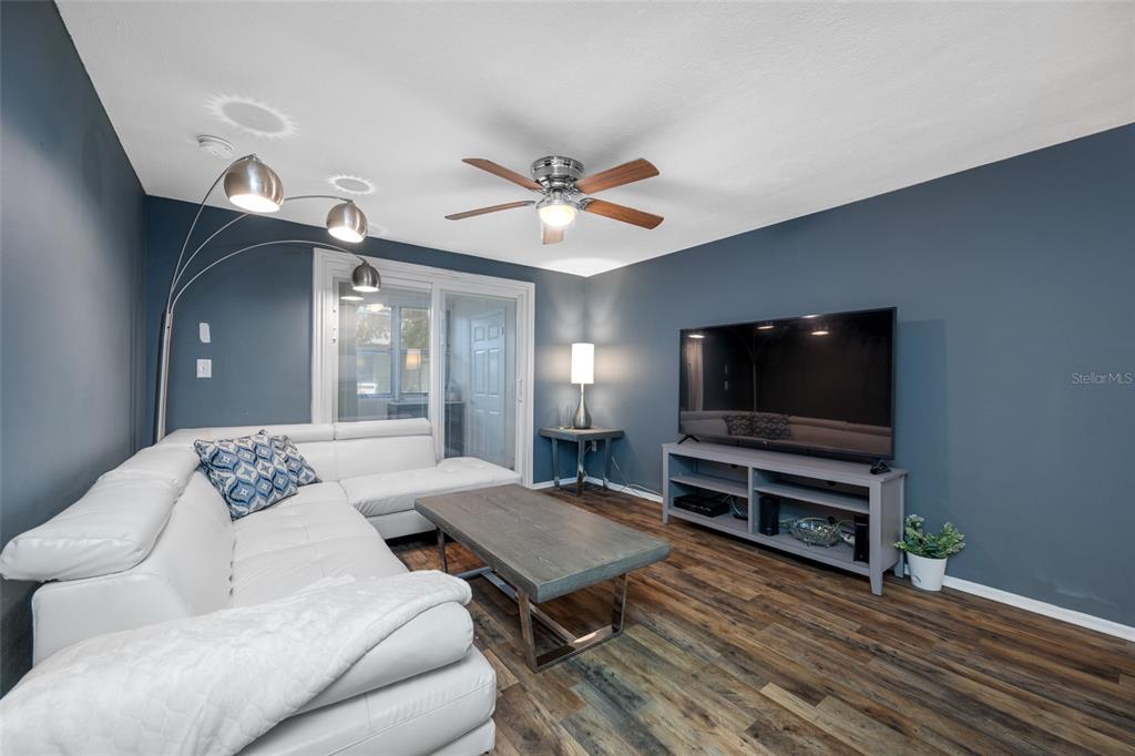4210 Touchton Place, Unit 2 New Port Richey, FL 34652 - Photo 15 of 34 a living room with furniture and a flat screen tv