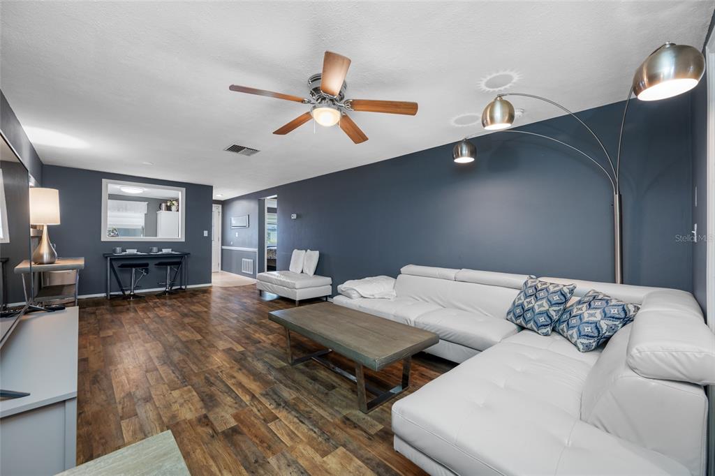 4210 Touchton Place, Unit 2 New Port Richey, FL 34652 - Photo 16 of 34 a living room with furniture and a wooden floor