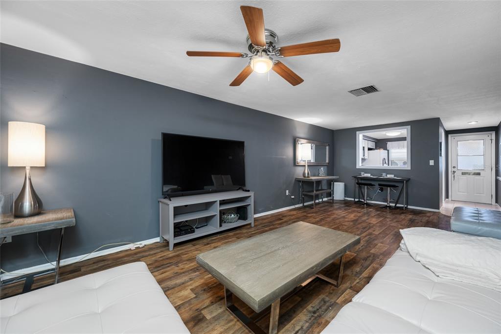 4210 Touchton Place, Unit 2 New Port Richey, FL 34652 - Photo 17 of 34 a living room with furniture and a flat screen tv