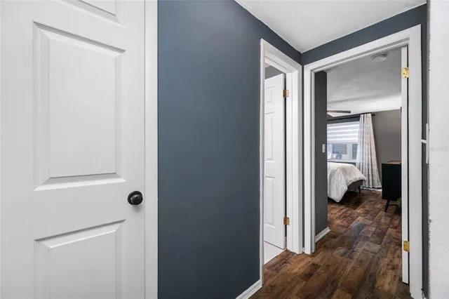 a bedroom with a bed desk and a window