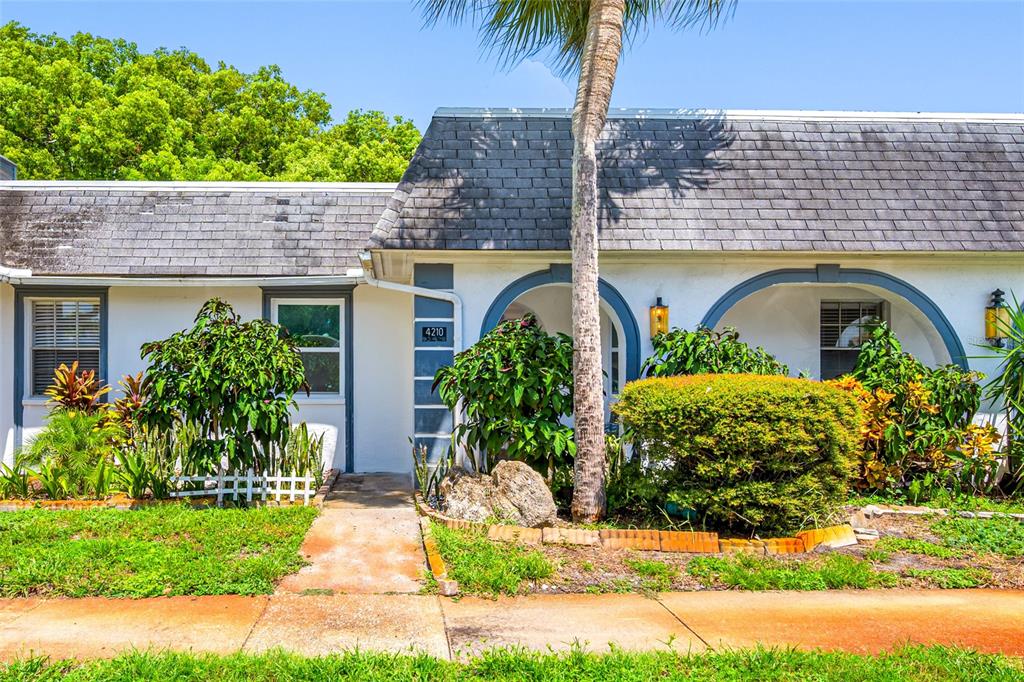 4210 Touchton Place, Unit 2 New Port Richey, FL 34652 - Photo 2 of 34 a house view with a garden space