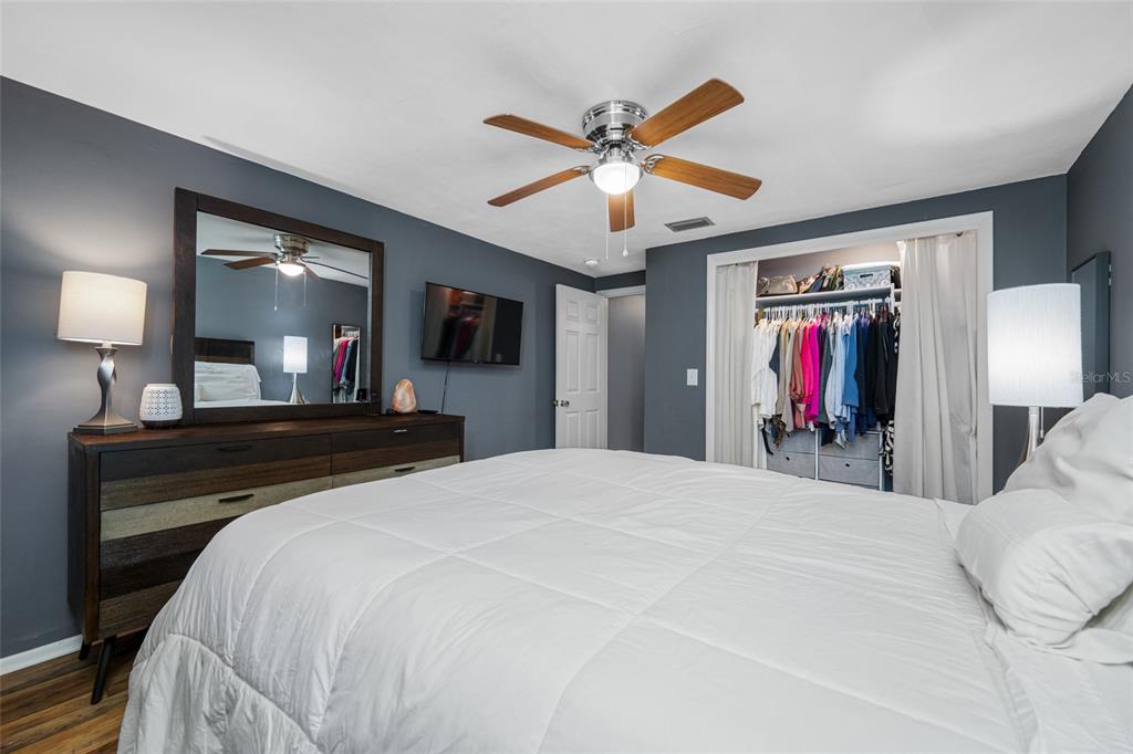 4210 Touchton Place, Unit 2 New Port Richey, FL 34652 - Photo 22 of 34 a bed room with a bed and a mirror