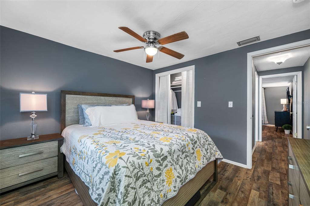 4210 Touchton Place, Unit 2 New Port Richey, FL 34652 - Photo 26 of 34 a bedroom with a bed and a chandelier