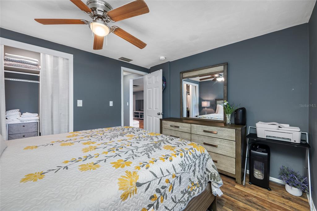 4210 Touchton Place, Unit 2 New Port Richey, FL 34652 - Photo 27 of 34 a bedroom with a bed and a chandelier