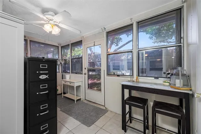 a view of a kitchen with refrigerator and wooden floor