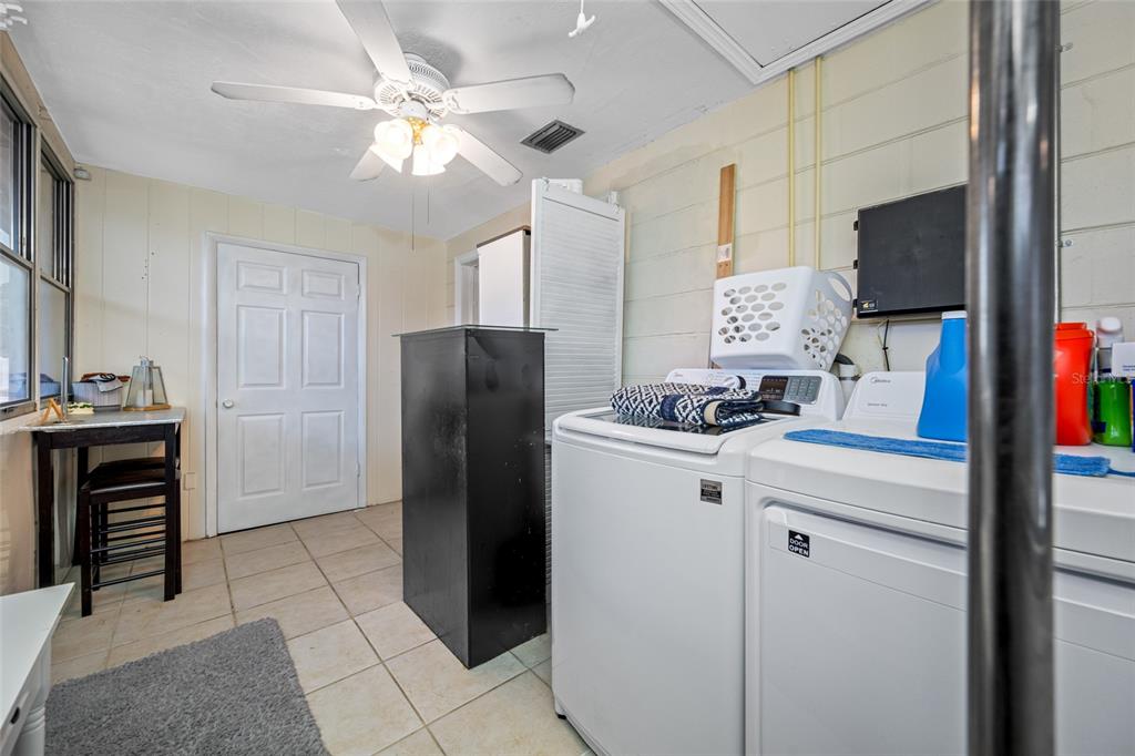 4210 Touchton Place, Unit 2 New Port Richey, FL 34652 - Photo 30 of 34 a kitchen with a refrigerator and a stove top oven
