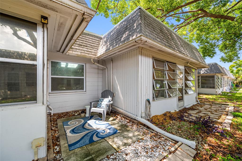 4210 Touchton Place, Unit 2 New Port Richey, FL 34652 - Photo 32 of 34 a front view of a house with garden