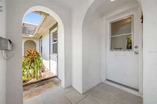 a view of a hallway with furniture and wooden floor