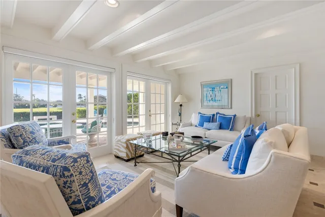 a living room with furniture and large windows