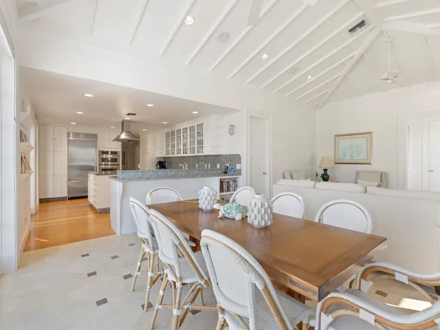 a view of a dining room with furniture and a chandelier
