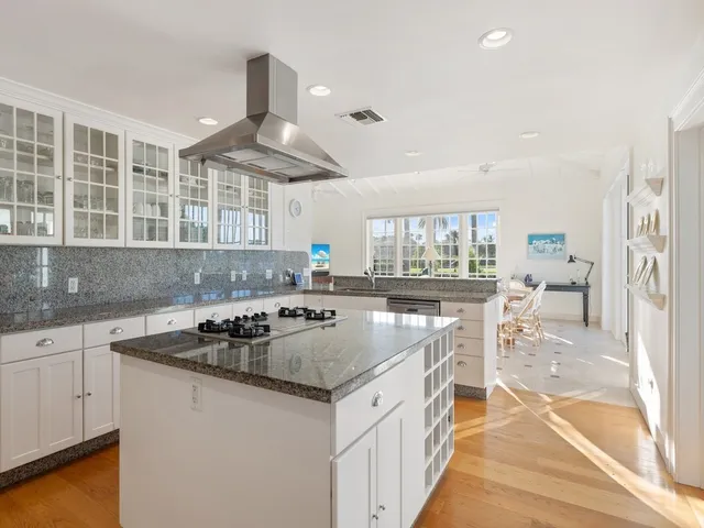 a kitchen with granite countertop a sink and a stove