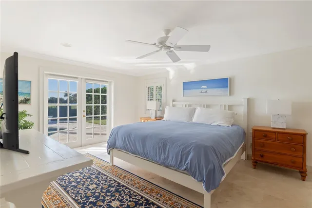 a bedroom with a bed a mirror and a window