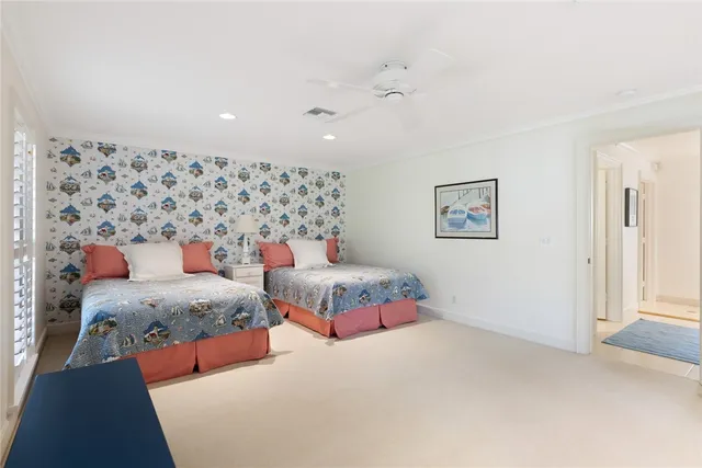 a bedroom with two beds and painting on the wall