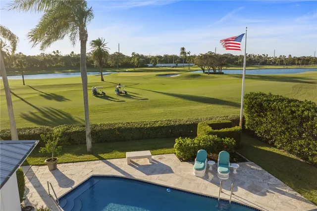 a view of a lake with a table and chairs