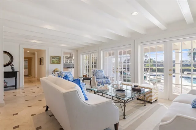 a living room with furniture and large windows