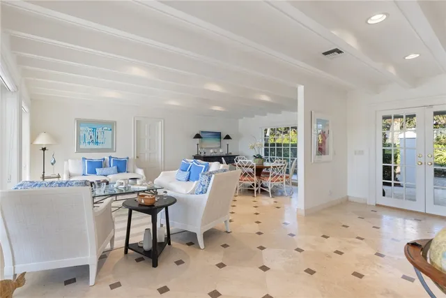 a room with furniture a wooden floor and a chandelier