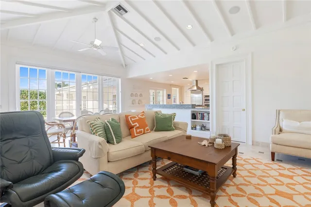 a living room with furniture a rug and a chandelier