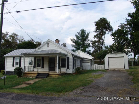 30 Fishersville Road Fishersville, VA 22939 - Photo 1 of 8 a view of a white house with large windows and a yard with plants and large tree
