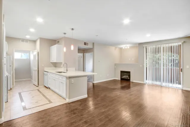 a large white kitchen with a large window appliances and cabinets