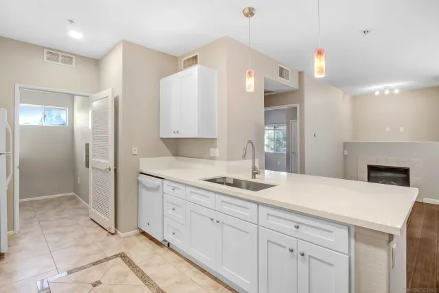 a kitchen with a sink and a refrigerator