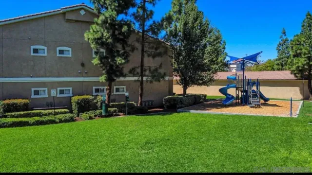 a view of a house with a yard and sitting area