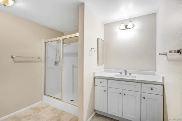 a bathroom with a double vanity sink and mirror