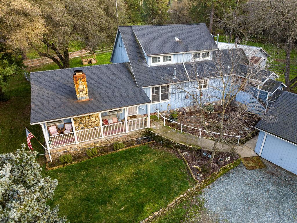 an aerial view of a house with a yard