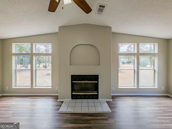a kitchen with stainless steel appliances granite countertop a sink and wooden floor