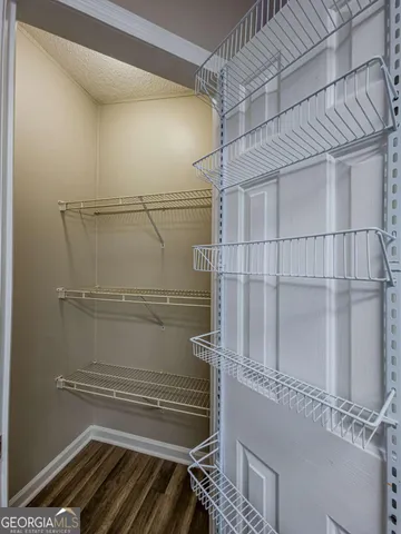 a bathroom with a granite countertop tub sink and mirror