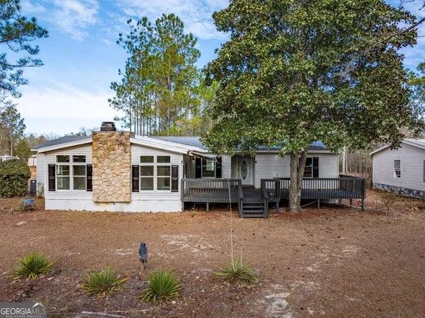 a view of a house with a yard and garage