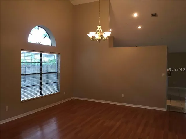 a view of a room with wooden floor and window