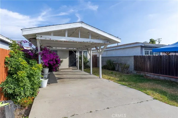 a front view of a house with plants